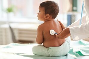 Baby getting a check-up from Doctor