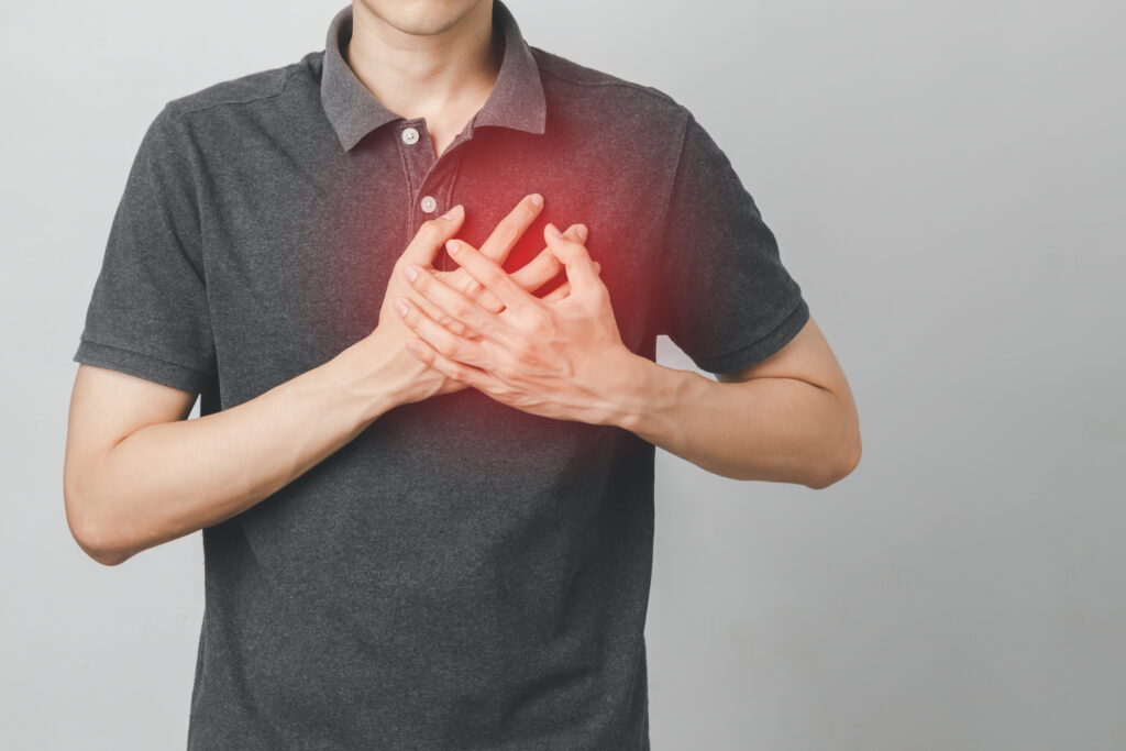Person holding chest with pain