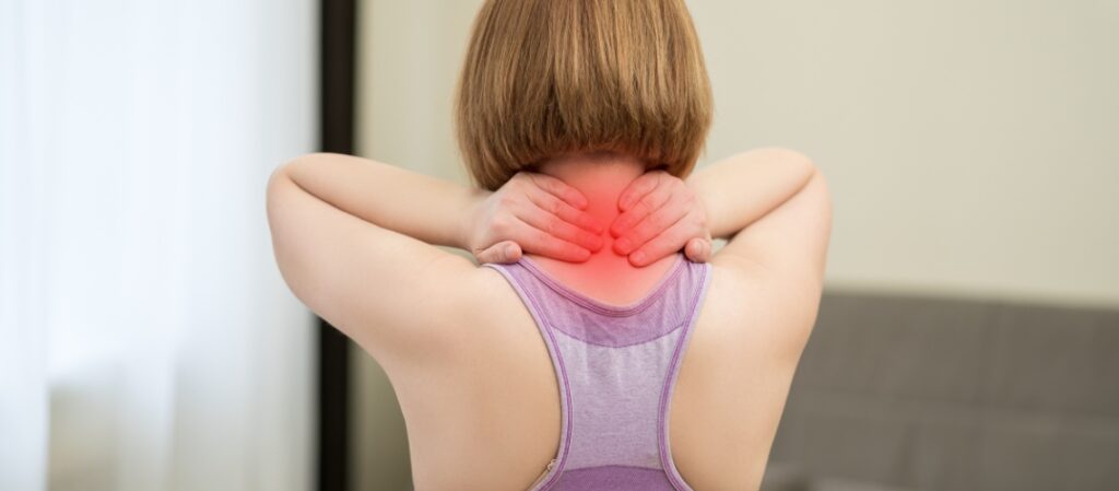 Woman holding neck in pain