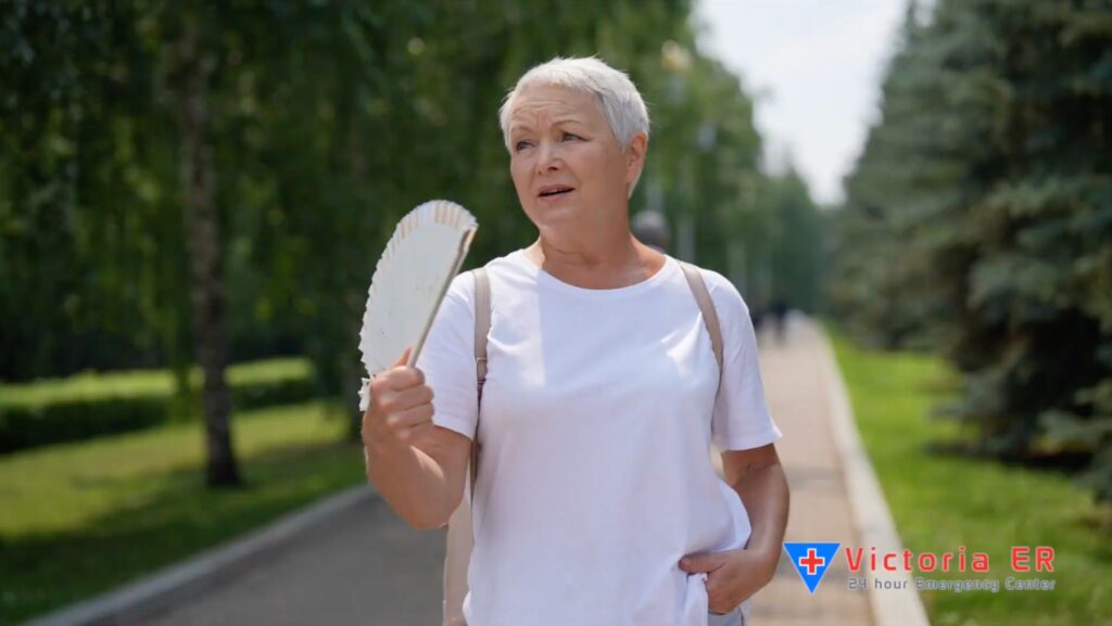Senior woman fanning herself