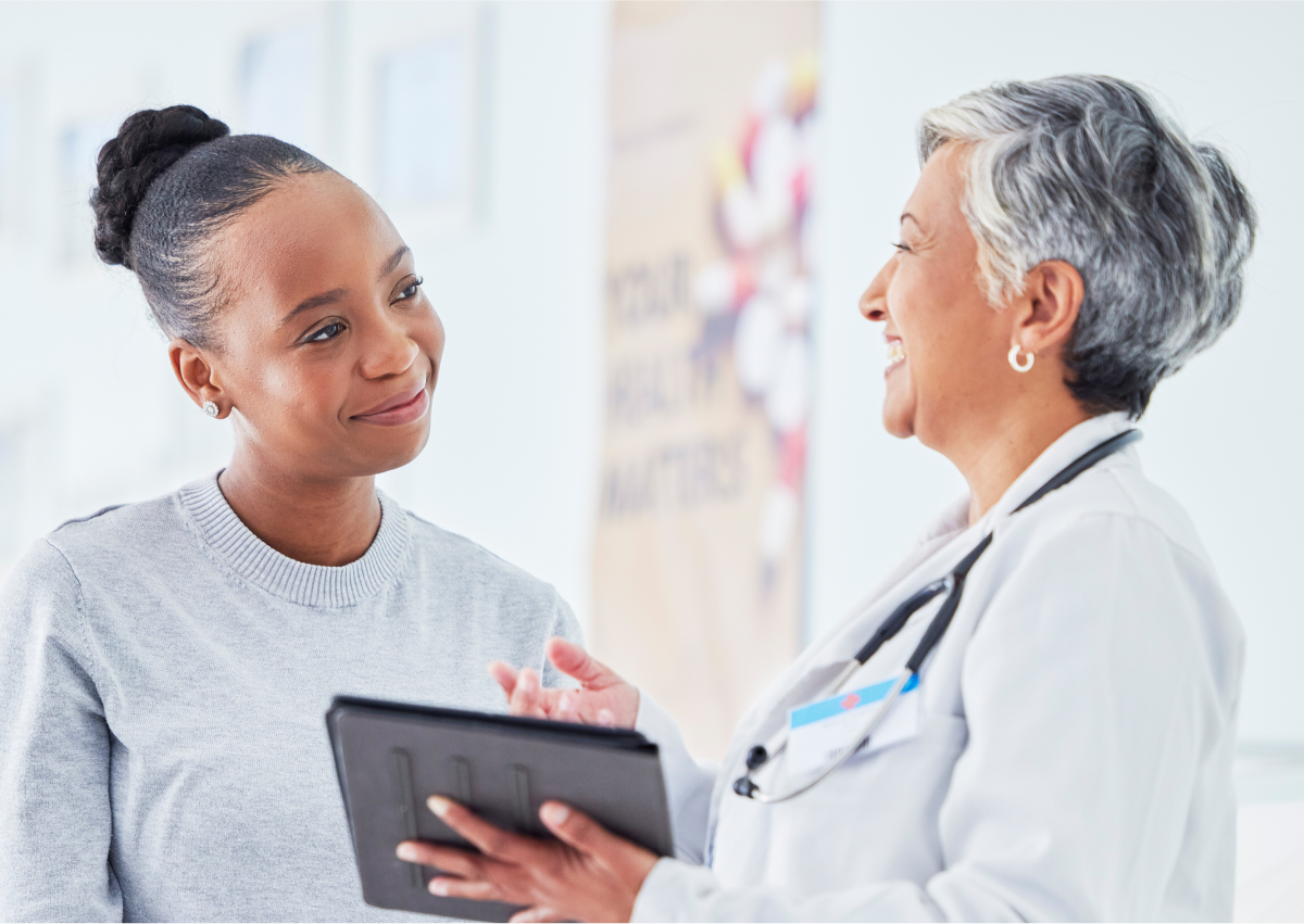 Happy doctor talking to patient