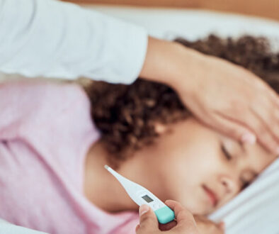 Flu-RSV A small girl getting her temperature taken