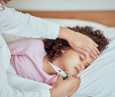 FluvsRSV A small girl getting her temperature taken